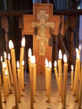 Burning candles in front of a cross in the Russian Chapel