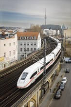 A Deutsche Bahn ICE train passes over the city railway line near Friedrichstrasse station in Berlin Mitte. The television tower can be seen in the background. Berlin