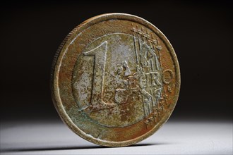 Symbol photo: Weathered 1 euro coin on a euro coin.Berlin