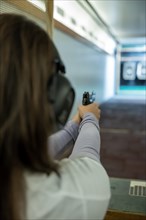 Woman Shooting with a Gun in Shooting Range with Target in Switzerland