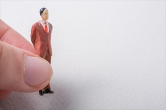 Tiny figurine of man miniature model in hand