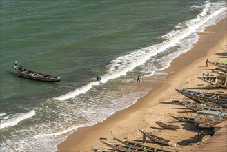 Fishing boats on the beach from the fish market in Bakau
