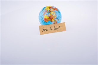 Globe and back to school title on a white background