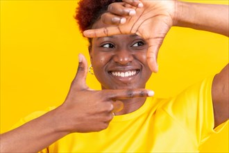 Young african american woman isolated on a yellow background with gesture square from fingers