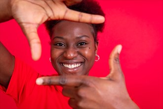 Young african american woman isolated on a red background with gesture square from fingers