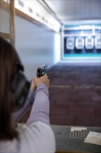 Woman Shooting with a Gun in Shooting Range with Target in Switzerland