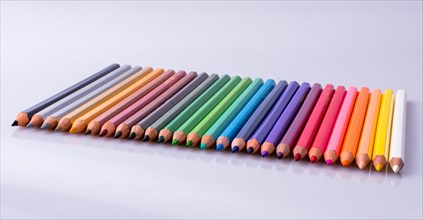 Color Pencils of Various colors placed on white background