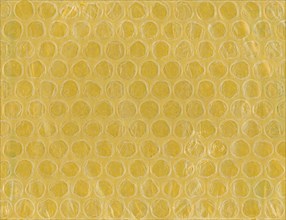 Yellow bubble wrap plastic and paper texture background