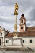 Marian column on the main square with the collegiate church of St. Vitus