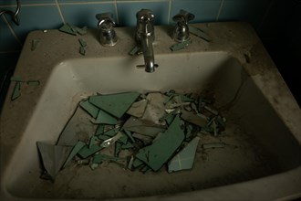 Abandoned House in Bathroom with Broken Mirror in Sink in Switzerland