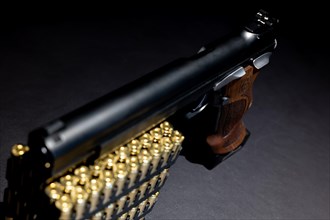 Elegant Semiautomatic 9mm Handgun with Swiss Helvetia Symbol Leaning on Bullet Ammunition in Switzerland