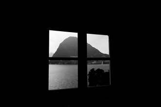 Window View over Lake Lugano with Mountain Peak Monte Bre and Sunlight in Lugano