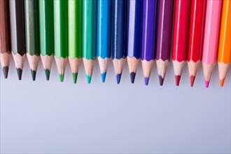 Color Pencils of Various colors placed on white background