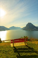 Bench on Lake Lugano and City with Mountain and Blue Sky in Park San Michele in Castagnola in Lugano