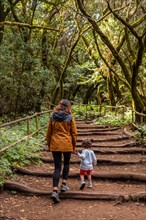 Mother and son walking along a path in the Garajonay natural park on La Gomera
