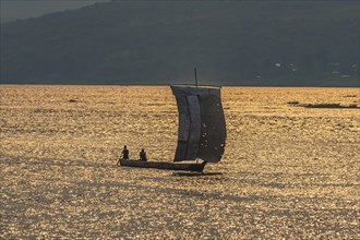 Traditional sailing boat on the Congo river at sunset
