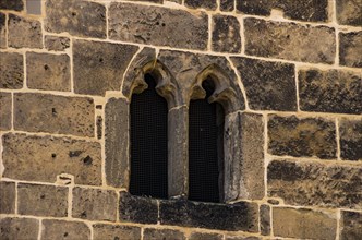 Medieval Gothic window in the form of two so-called nuns' heads in the market church of St. Benedikti