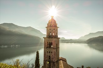 Church Tower Santa Maria del Sasso with Sunlight and Mountain on Lake Lugano in Morcote