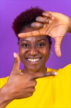 Young african american woman isolated on a purple background with gesture square from fingers