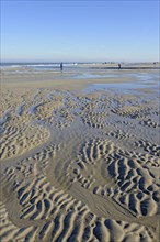 Beach at low tide with wave-like pattern