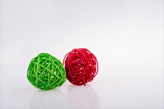 Red and green wooden balls on a white background