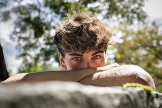 Young man falls his head down on his arms