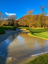 Sand Trap with Ice and Trees and Mountain with Sky and Sunlight in Lugano