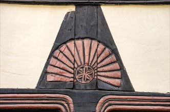 Carved fan rosette on the half-timbering of a historic building in Hoelle