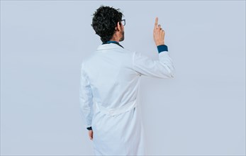 Doctor posing from back pointing finger. Young doctor from back pointing finger isolated