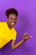 Young african american woman isolated on a purple background inviting to come with her hand