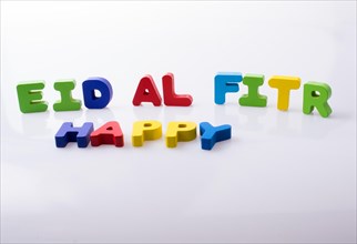 The word EID EL FITR written with colorful letter blocks