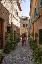 Tourists walk through alley