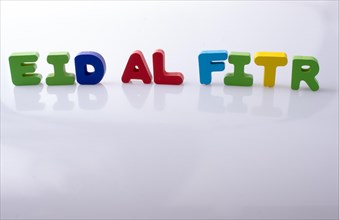 The word EID EL FITR written with colorful letter blocks