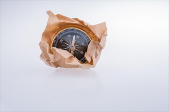 Black compass instrument wrapped in brown paper