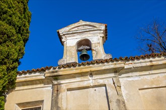 Church with Bell and a tree with Clear Blue Sky in Park San Michele in Castagnola in Lugano