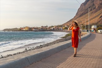 Tourist at sunset walking on the beach of the town of Valle Gran Rey in La Gomera