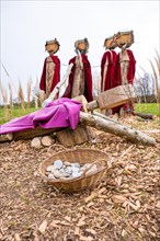Wooden figures with spears against Jesus on Easter path