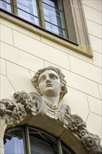 Facade detail with window and beautiful woman's head