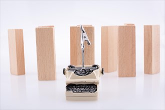 Typewriter and domino pieces positioned on white background
