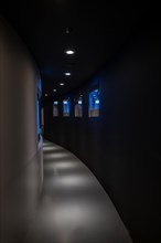 Illuminated Corridor with TV Screens in Switzerland