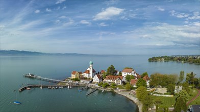 Aerial panorama of the moated castle peninsula on Lake Constance with the baroque church of St. George