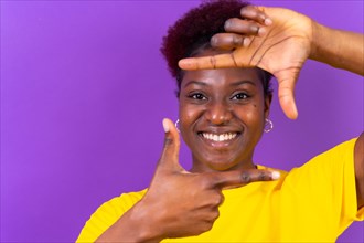 Young african american woman isolated on a purple background with gesture square from fingers