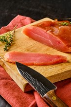 Closeup view of air dried turkey breast on wooden cutting board