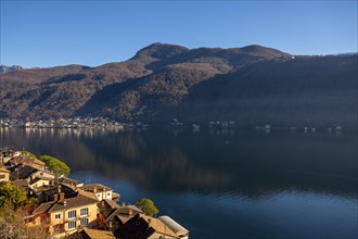 Cityscape and Lake Lugano with Blue Sky and Mountain in a Sunny Day in Morcote
