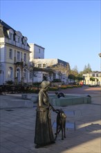 Statue of a woman with a goat on the main street