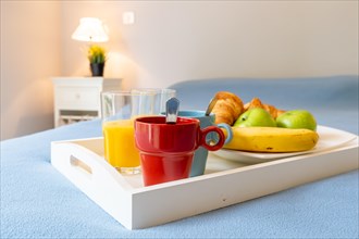 Breakfast on a red bed