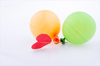 Red heart and colorful small balloons on a white background