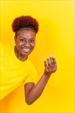 Young african american woman isolated on a yellow background inviting to come with her hand