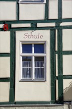 Old half-timbered house with the inscription SCHULE