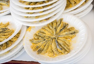 Set of plates with fried anchovies fish as seafood